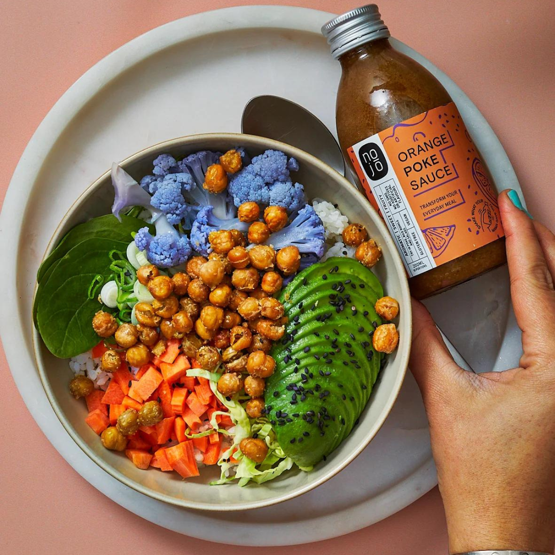 orange chickpea poke bowl with nojo orange sauce